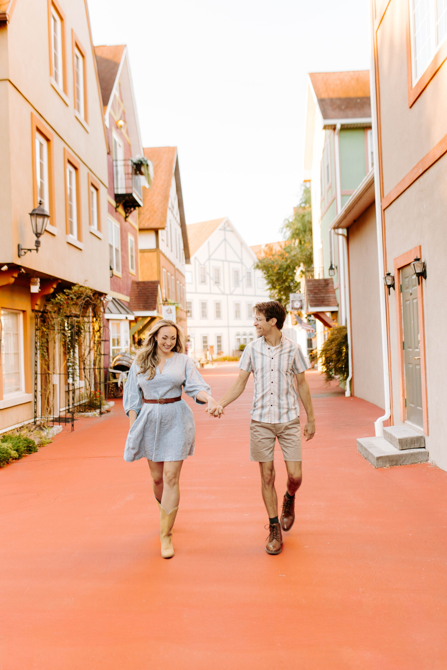 Couple walking hand in hand during a couples photo session in Stoudtburg Village in Reinholds, Pennnsylvania